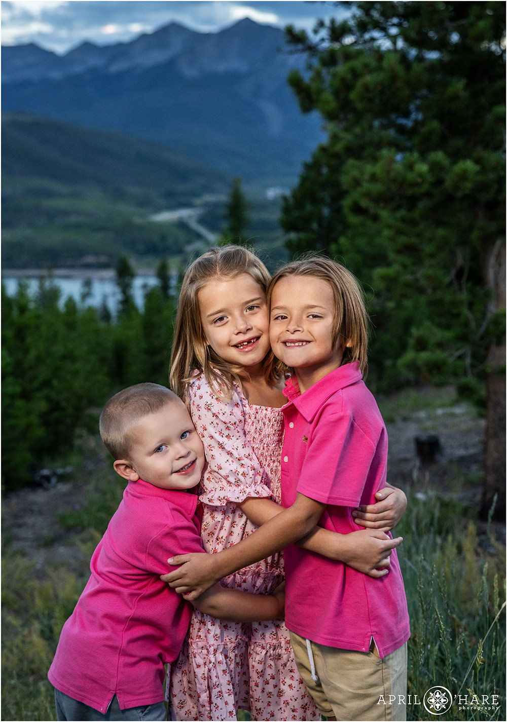 Cute young cousins hug each other at their family photos in Colorado