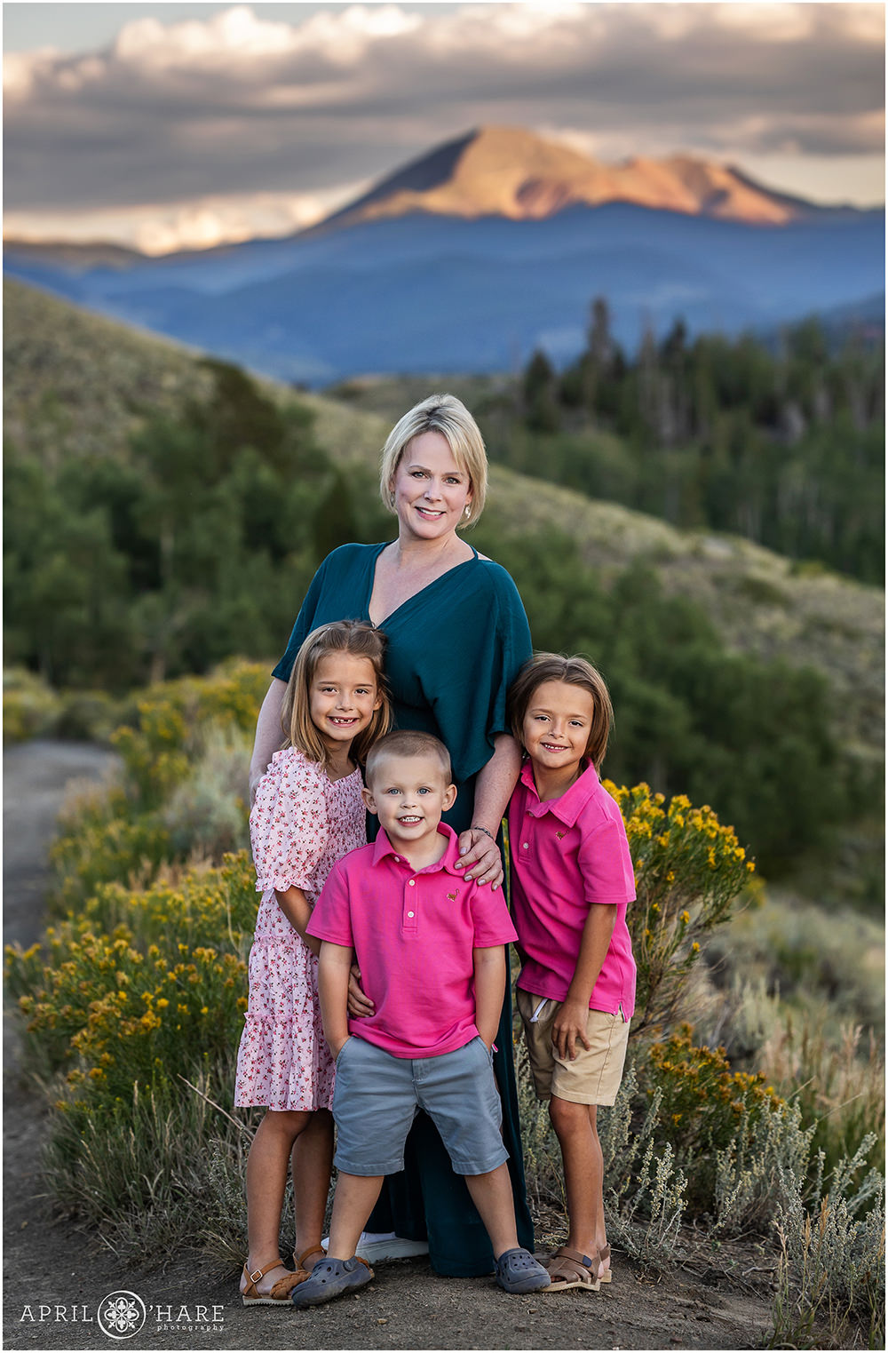A grandmother with her grandchildren with a pretty mountain backdrop near Keystone Colorado