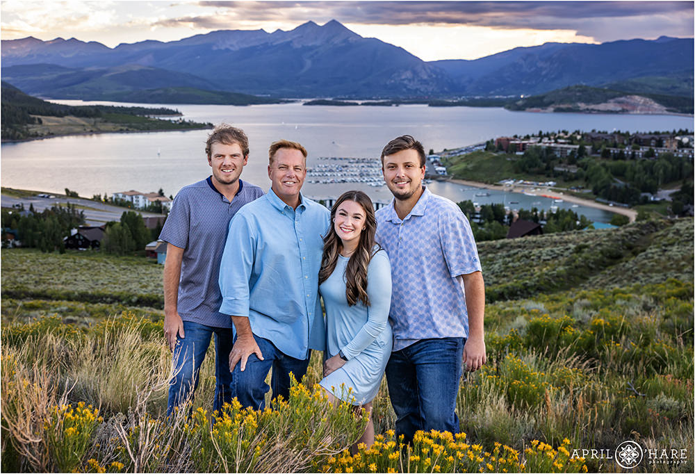 A dad with his two sons and daughter in law in Colorado with Ten Mile Range and Lake Dillon in the backdrop