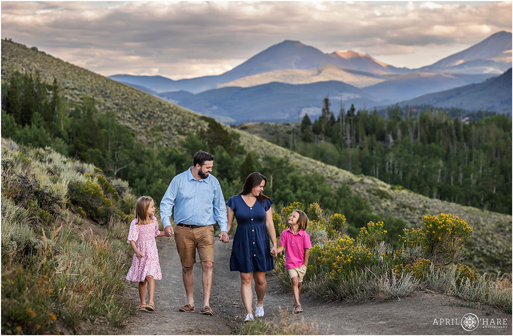 A cute family of 4 with two young kids walk down the Tenderfoot Mountain Trailhead in Summit County Colorado