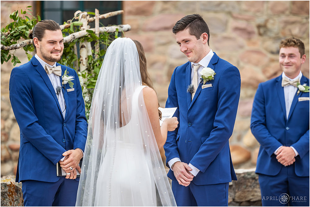 Groom smiles at his bride at their Colorado Castle wedding