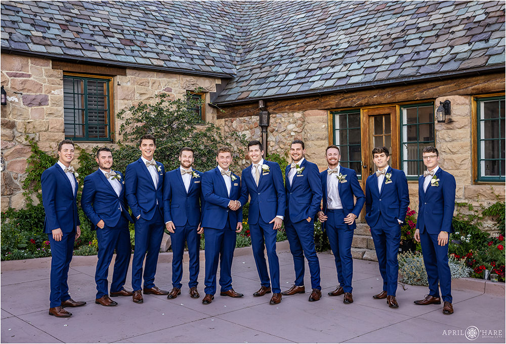 Groom and groomsmen wearing blue suits at his castle wedding in Colorado