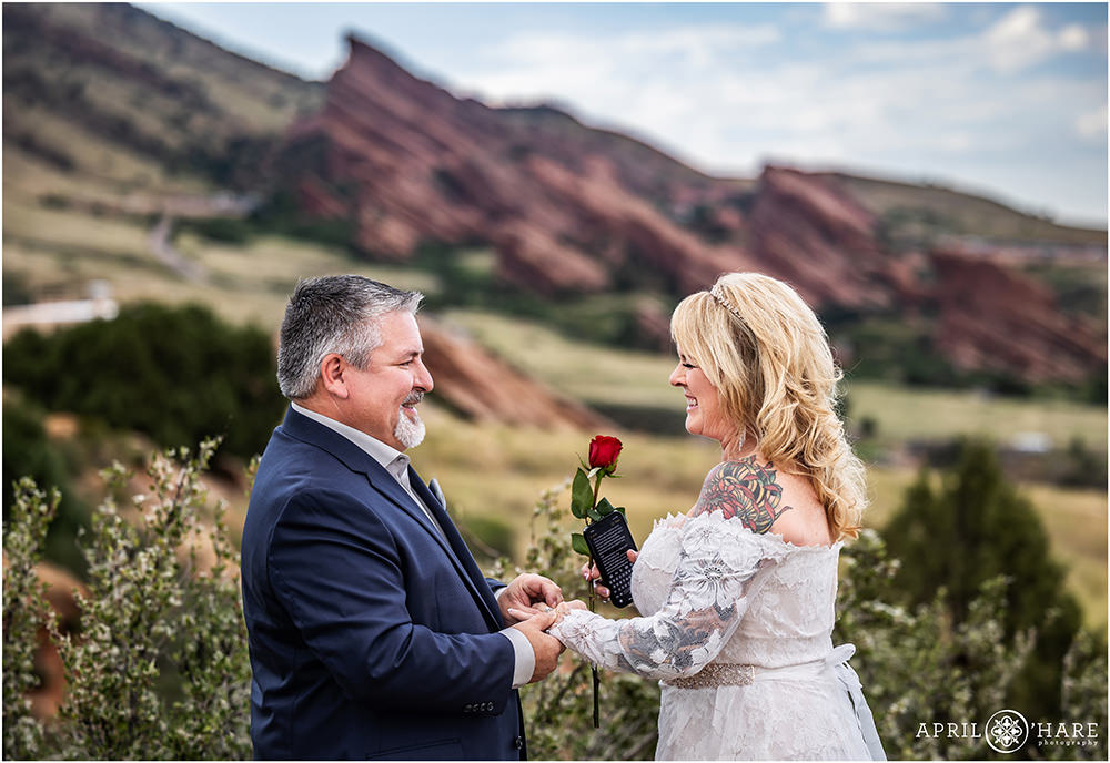 Couple laugh as they exchange rings at their outdoor Colorado elopement at East Mount Falcon Trailhead