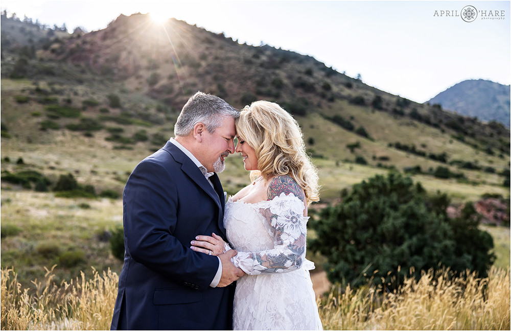 Gorgeous backlit sunset photo of a couple on their elopement day at East Mount Falcon Trailhead in Colorado