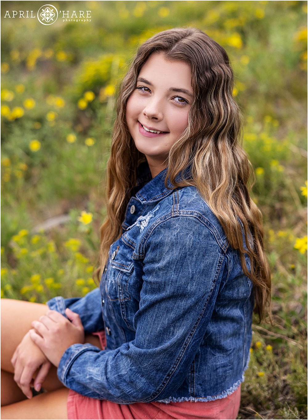 Beautiful portrait of a senior girl in the wild flowers at Rocky Mountain National Park in Colorado