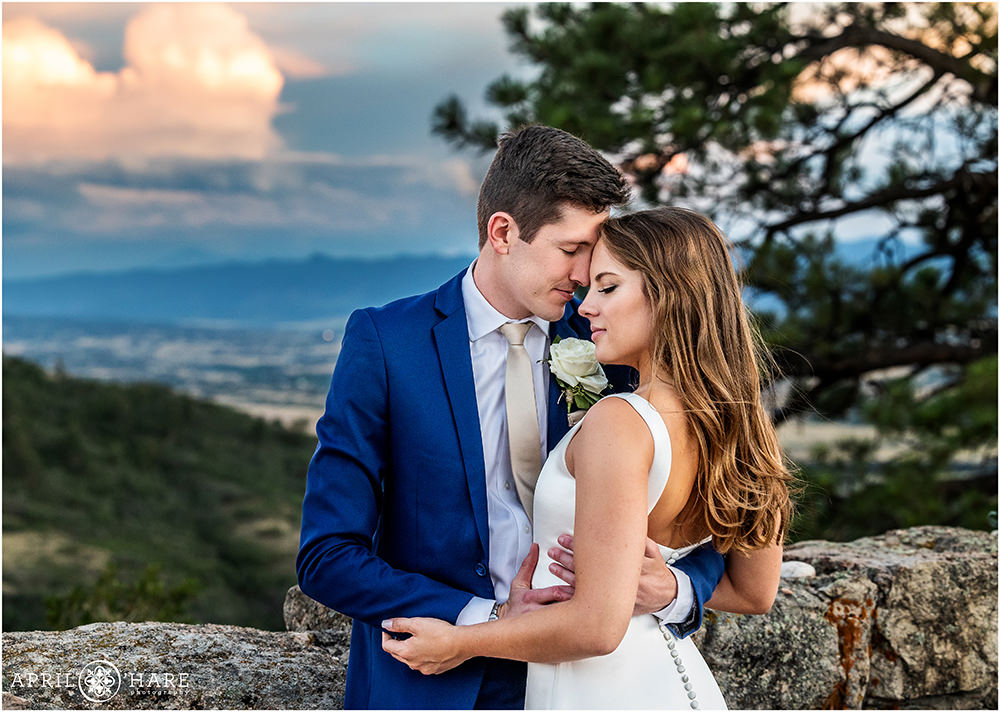 Gorgeous romantic wedding portrait with dramatic sunset sky in Colorado