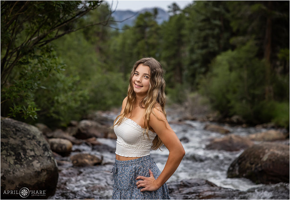 Pretty summer senior photo next to a river in the Rocky Mountains of Colorado