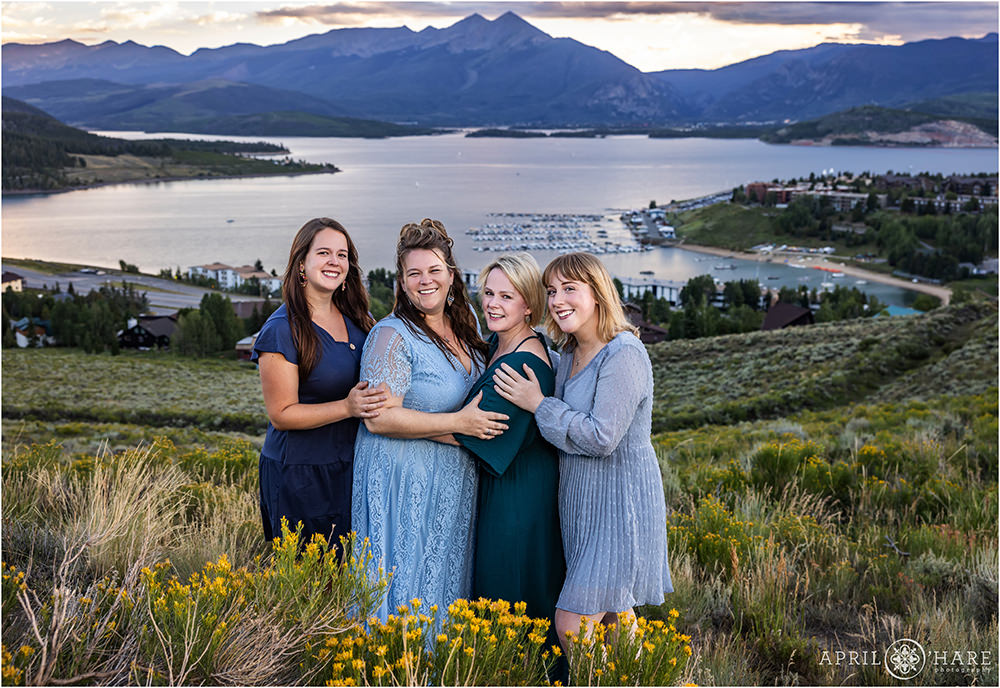 A mom with her daughters with Lake Dillon and the Marina in the backdrop in Dillon Colorado