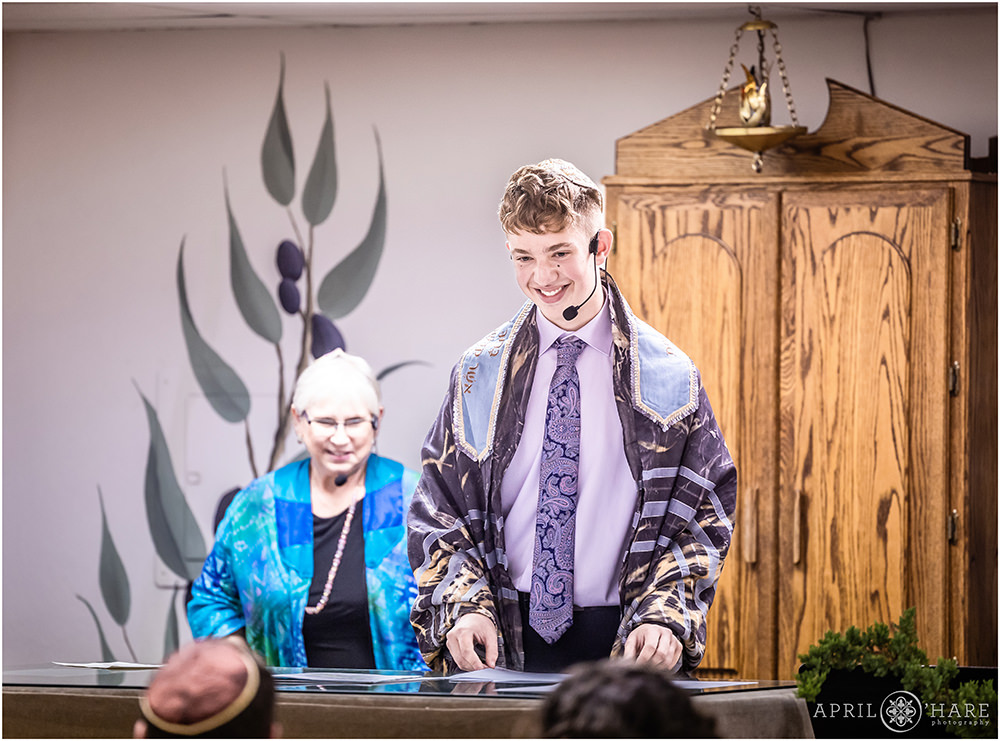 Bar Mitzvah boy smiles at his parents during his bar mitzvah service in Colorado