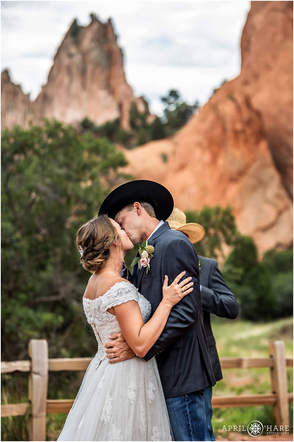 Bride and groom kiss at their wedding ceremony at Garden of the Gods