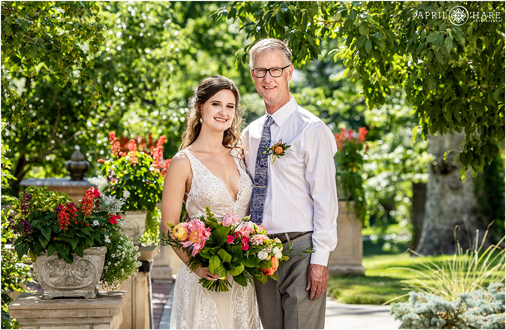 Bride with her dad pose for portraits on a sunny summer day at Grant-Humphreys Mansion in Denver