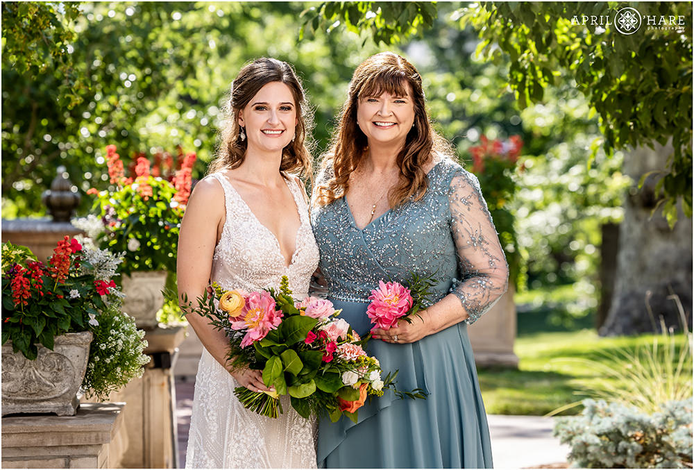 Bride with her mom pose for outdoor portrait on a sunny day at Grant-Humphreys Mansion