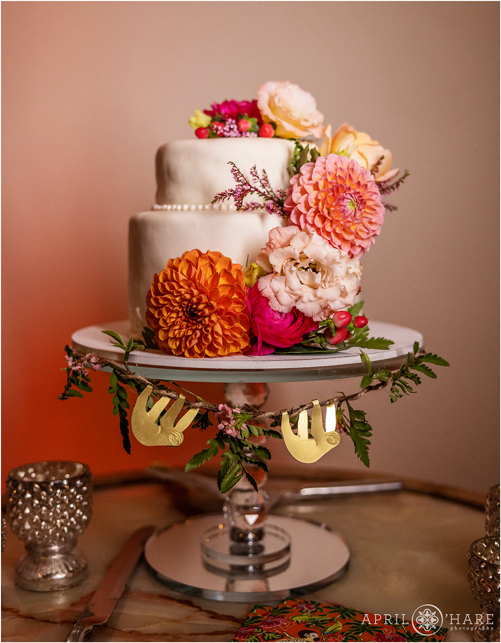 Gorgeous cute little white cake decorated with citrus colored florals at Grant-Humphreys mansion in Denver