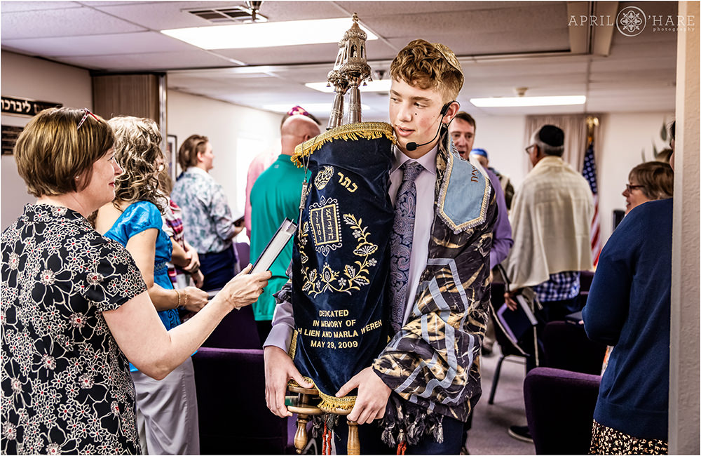 Boy carries the torah through the congregation at B'Nai Chaim on the day of his Bar Mitzvah