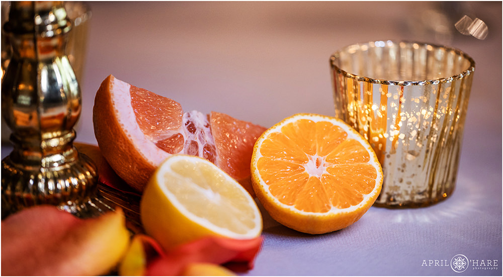 Sliced citrus fruit decorate a wedding table at Grant Humphreys Mansion in Denver