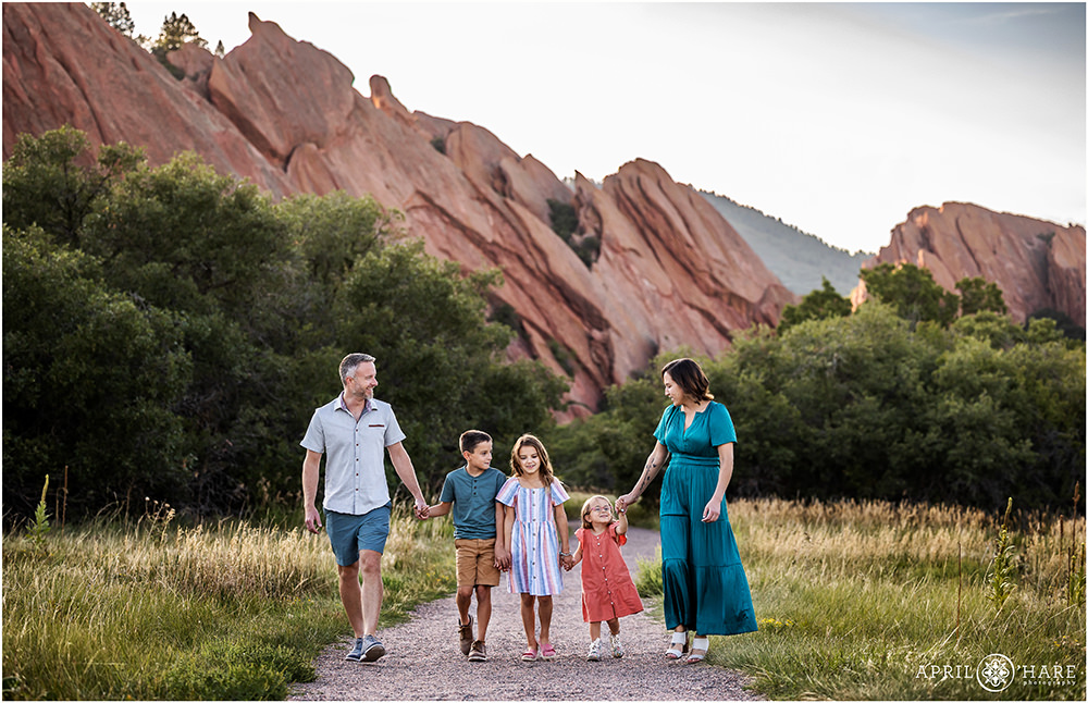 Family of 5 walk together down the path at Roxborough State Park in Colorado