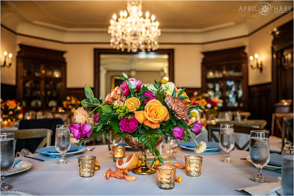 Grant-Humphreys Mansion set up for a wedding dinner using citrus fruits and bright orange and pink florals