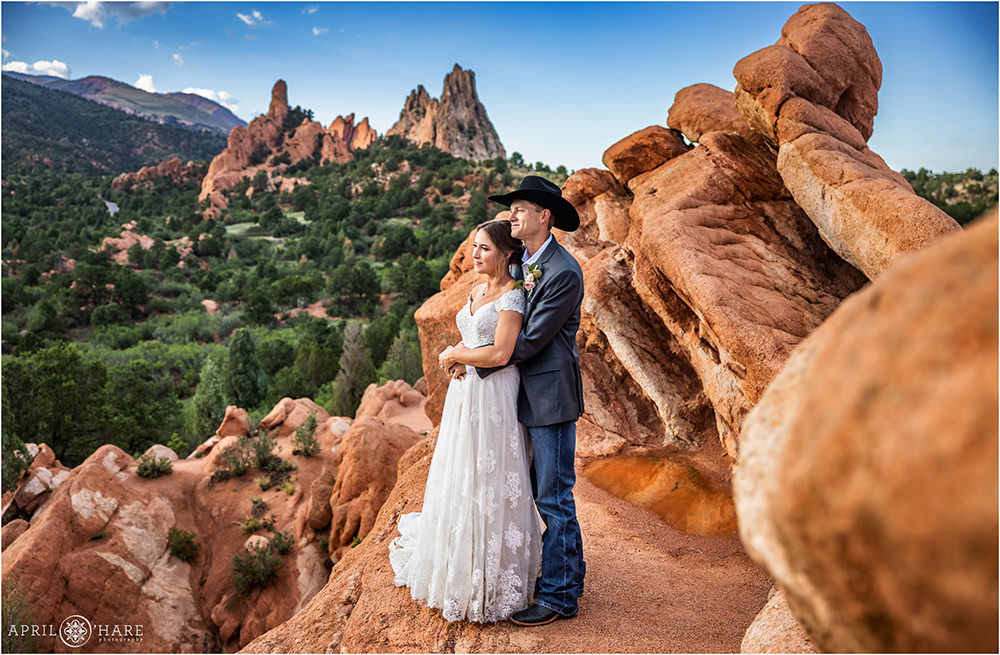 Bride and groom look out at the mountain scenery after their outdoor wedding ceremony at Garden of the Gods in Colorado Springs