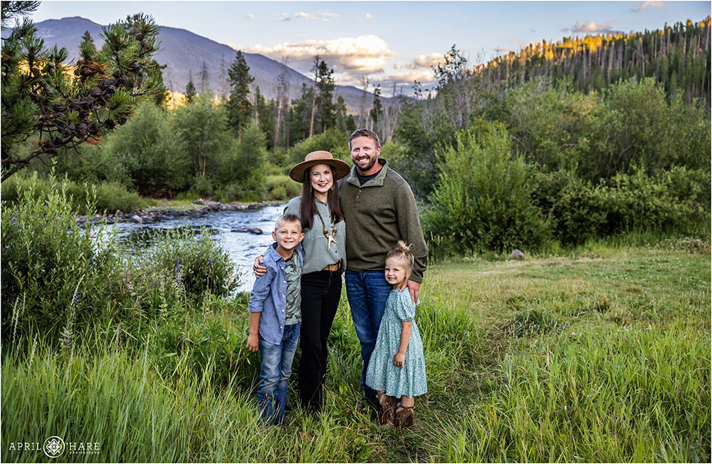 Cute family of 4 with Colorado River backdrop in Grand Lake, Colorado