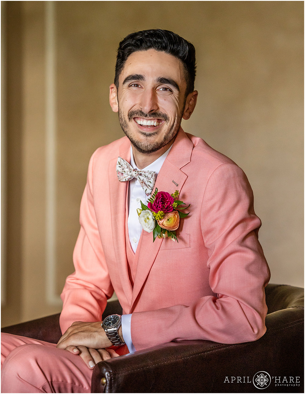 Classic portrait of a groom wearing a pink suit at the Grant-Humphreys Mansion in Denver