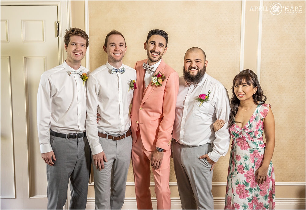 Groom poses for a portrait with his friends in the groom's room at Grant-Humphreys Mansion in Denver
