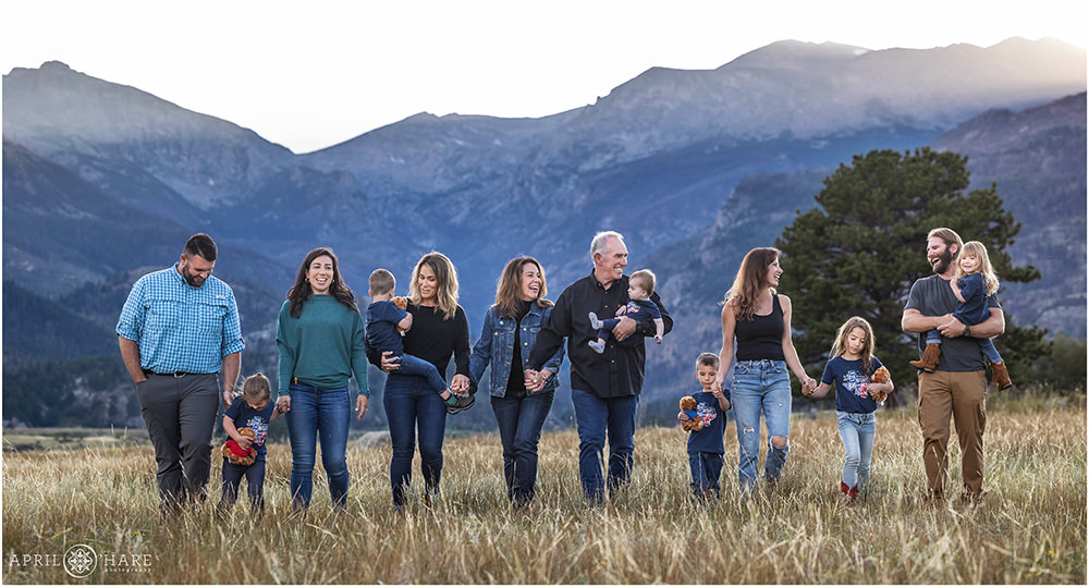 Extended family walk through a field at Rocky Mountain National park in Colorado
