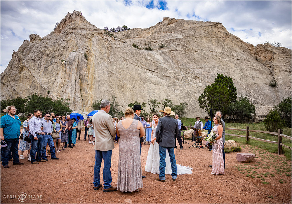 Outdoor wedding ceremony with white rock backdrop at Jaycee Plaza at Garden of the Gods in Colorado Springs