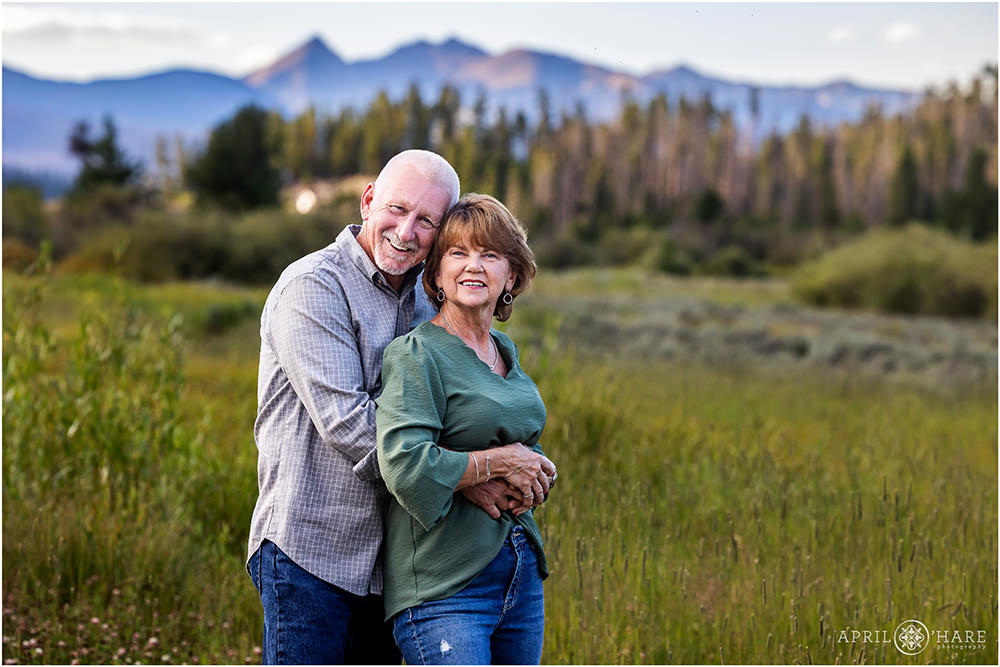 Couple pose for a sweet photo together with a pretty purple mountain backdrop in Colorado