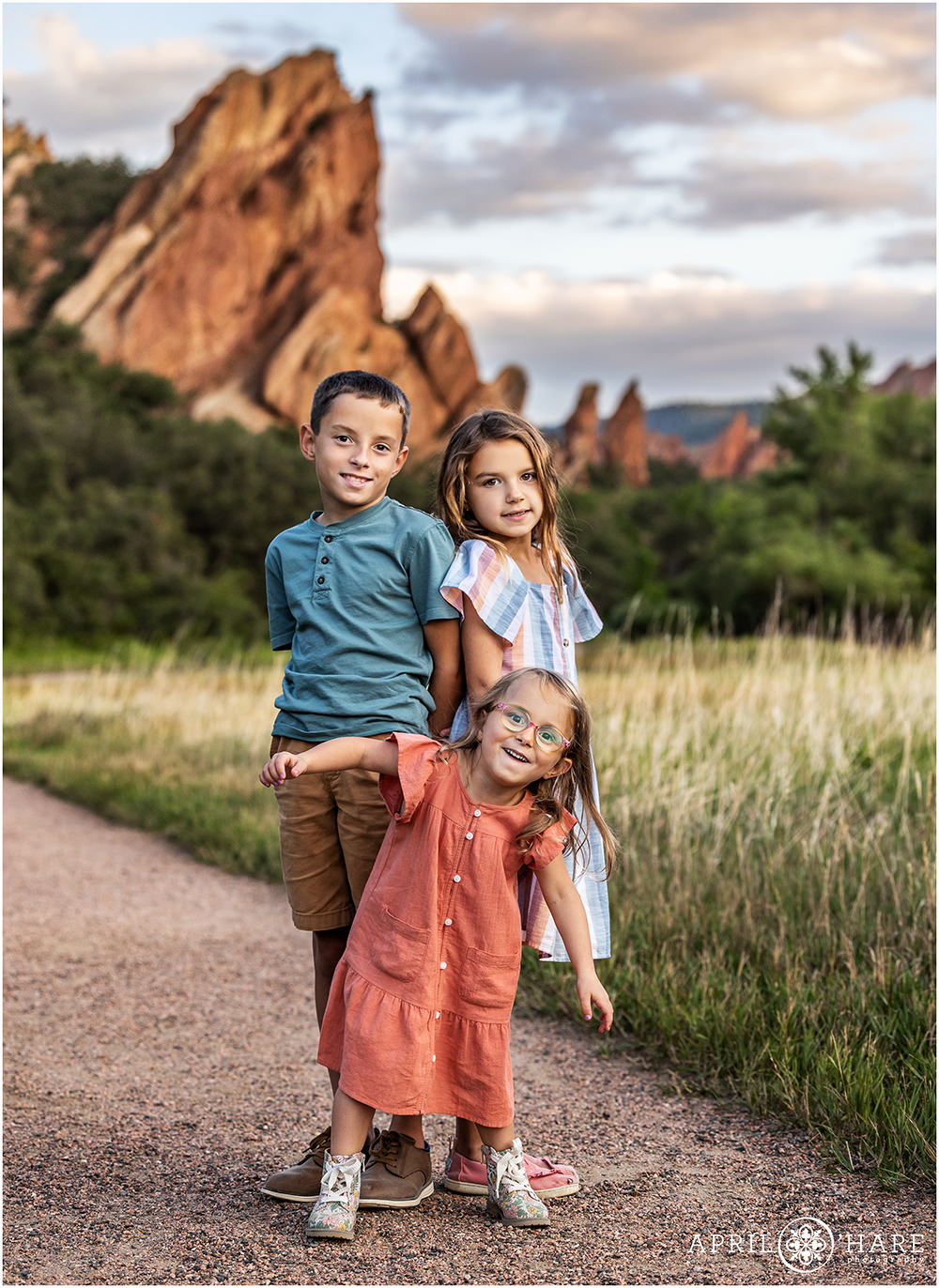 Three siblings pose for a photo at Roxborough State Park in Littleton CO