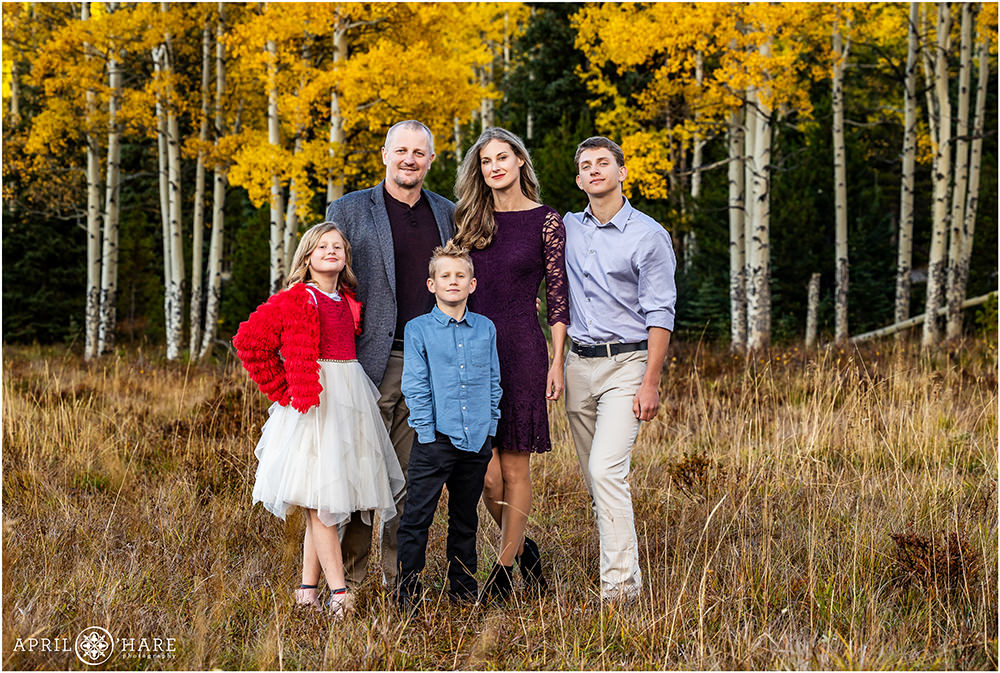 Beautiful family of 5 are photographed in a pretty Colorado mountain meadow during autumn