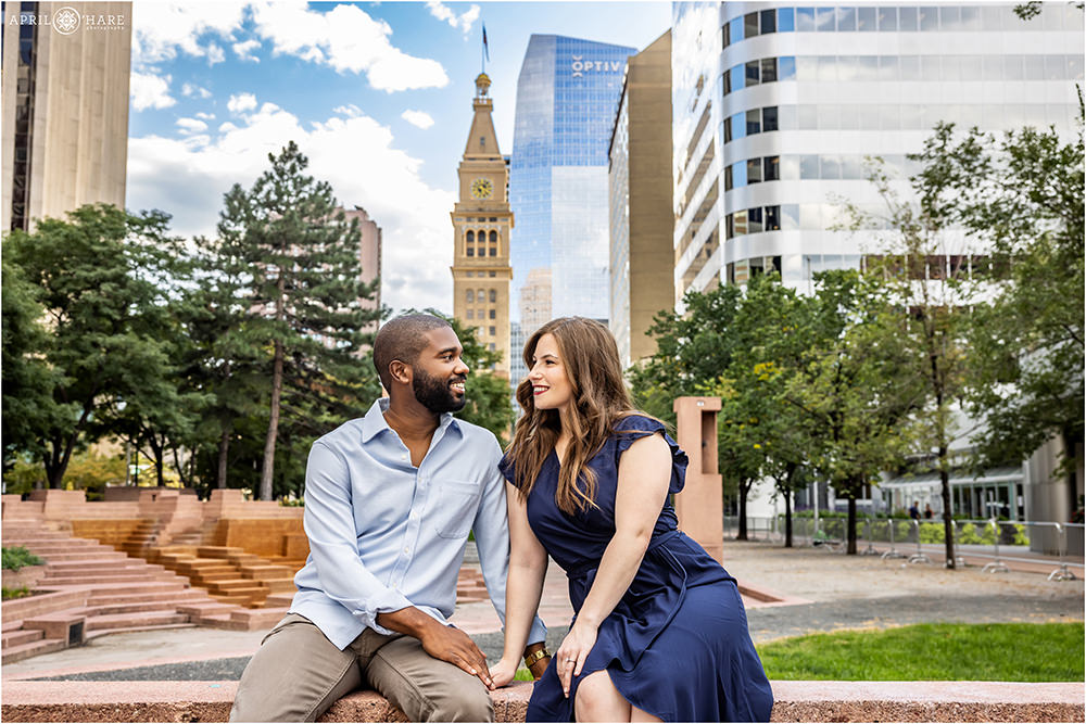 Cute couple photographed at Skyline Park in Downtown Denver with the Daniels & Fisher Clocktower in the backdrop