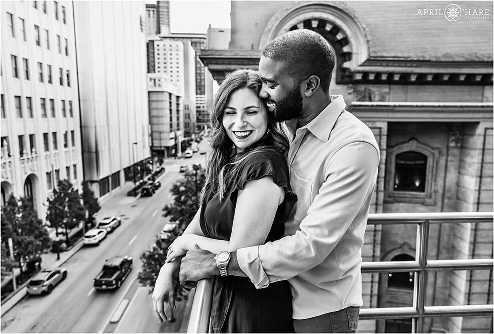 B&W portrait of a couple looking out over the street at the Denver Center for Performing Arts in Denver Colorado