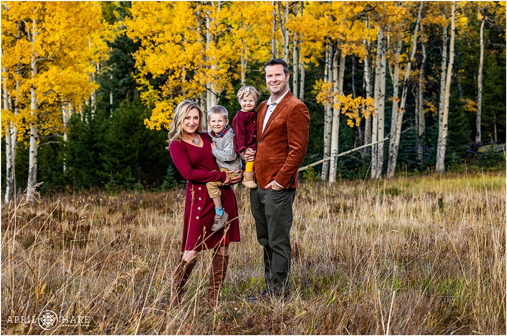 Sweet family of 4 fall color portrait on Squaw Pass Road in Evergreen Colorado