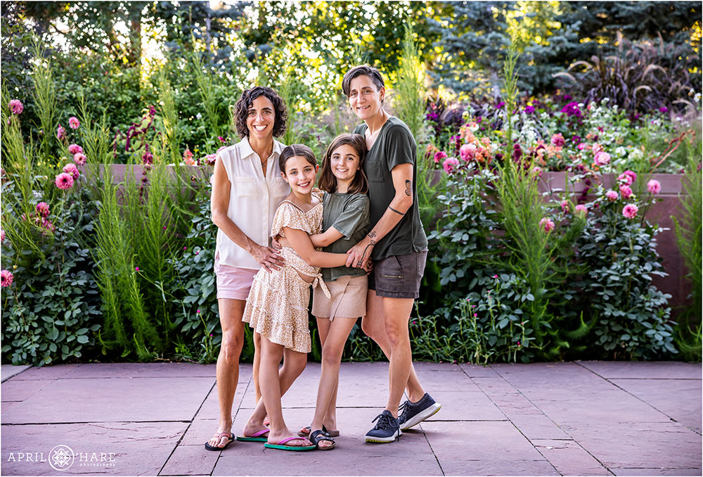Cute family photo with beautiful pink flower garden backdrop at Denver Botanic Gardens