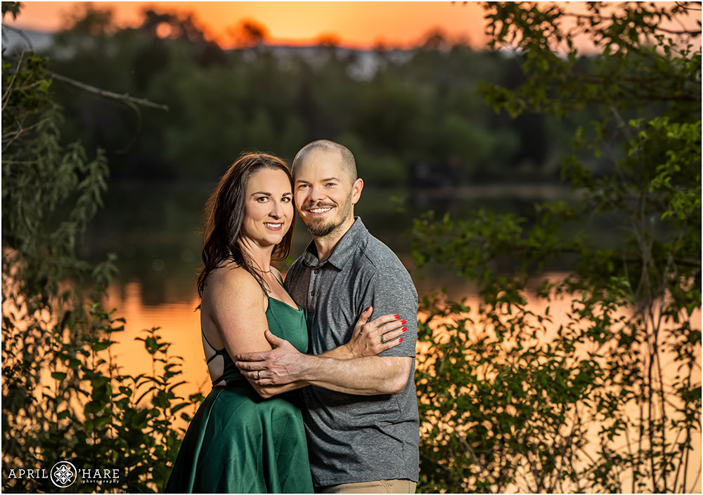 Couples portrait with a beautiful sunset lake backdrop at Kountze Lake at Belmark Park