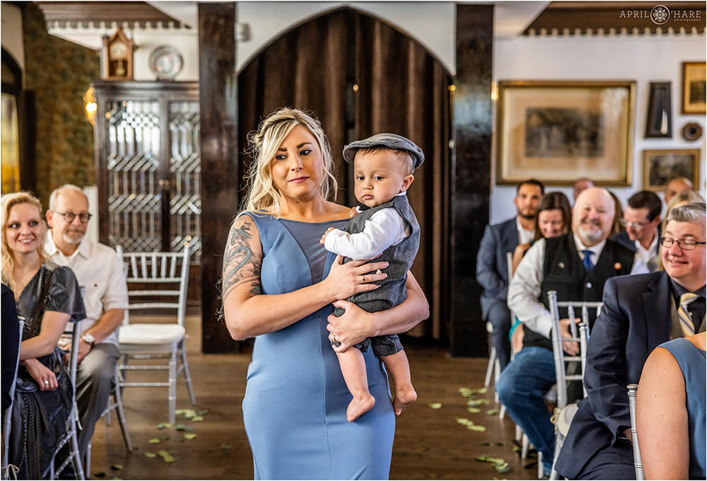 Bride and groom's baby son is walked down the aisle at their Wellshire Event Center wedding