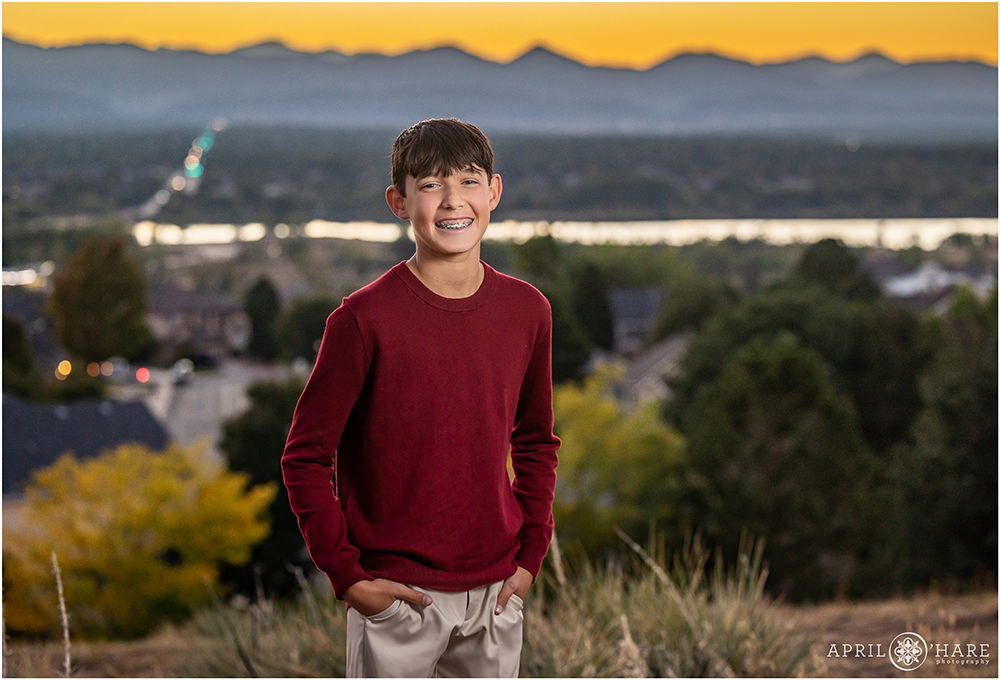 Kid portrait at Jackass Hill with orange and blue mountain sunset backdrop in Littleton