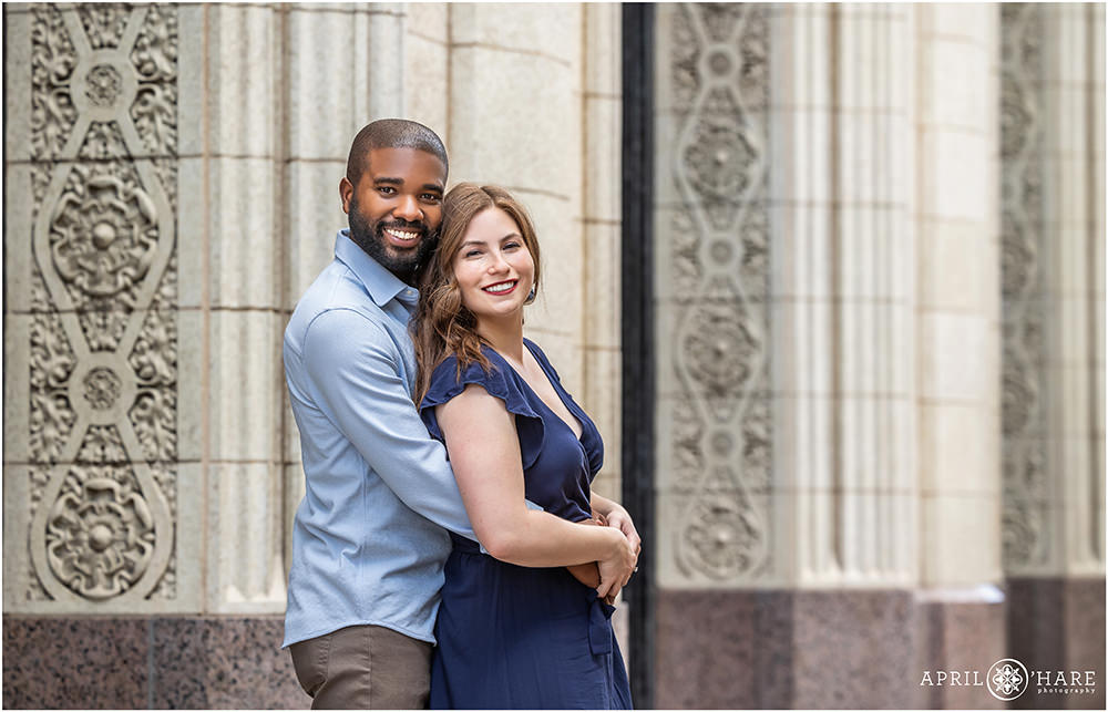 Mountain States Telephone & Telegraph art deco building backdrop for a cute engagement photo in downtown Denver Colorado