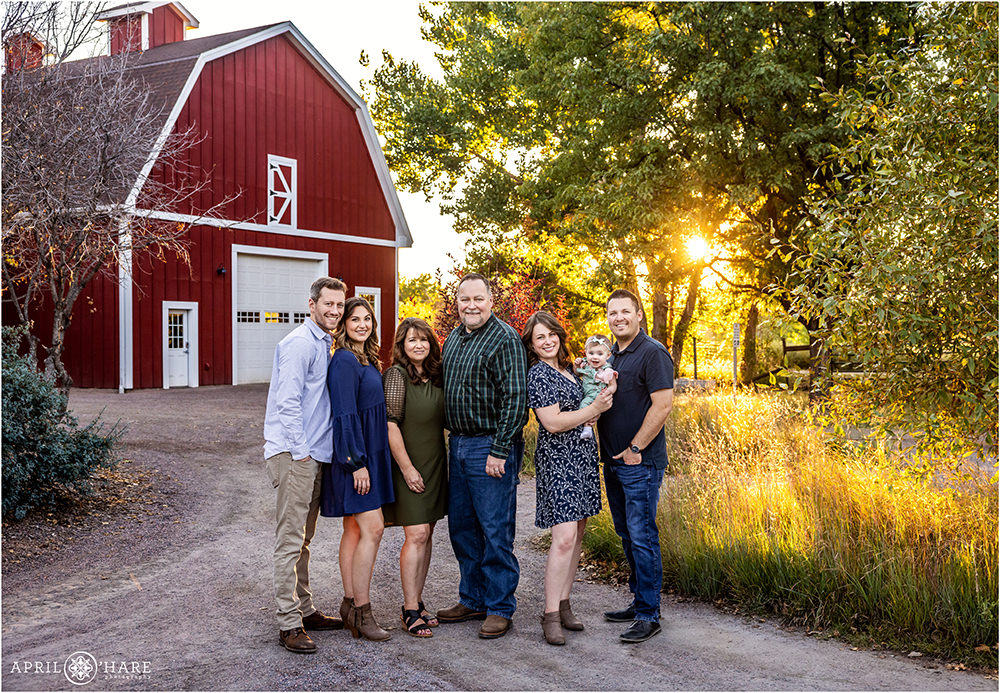 Extended family portrait with red barn backdrop at Hudson Gardens in Littleton Colorado