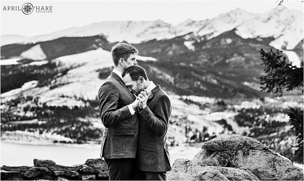 B&W photo of two grooms slow dancing at the end of their outdoor wedding ceremony at Sapphire Point