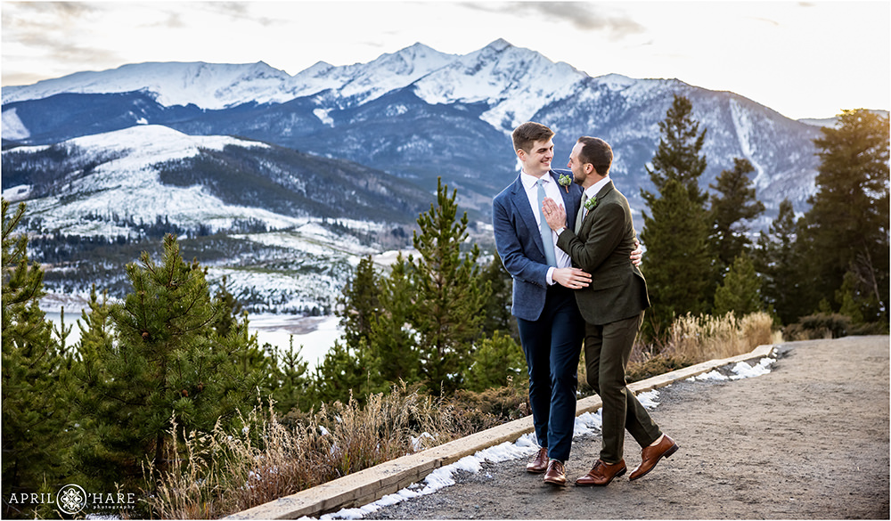 Two grooms walk down the path at Sapphire Point in Colorado