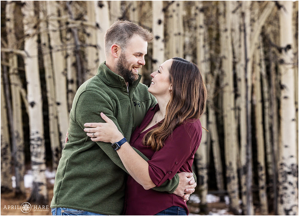 Cute couples portrait with aspen tree backdrop in Evergreen CO