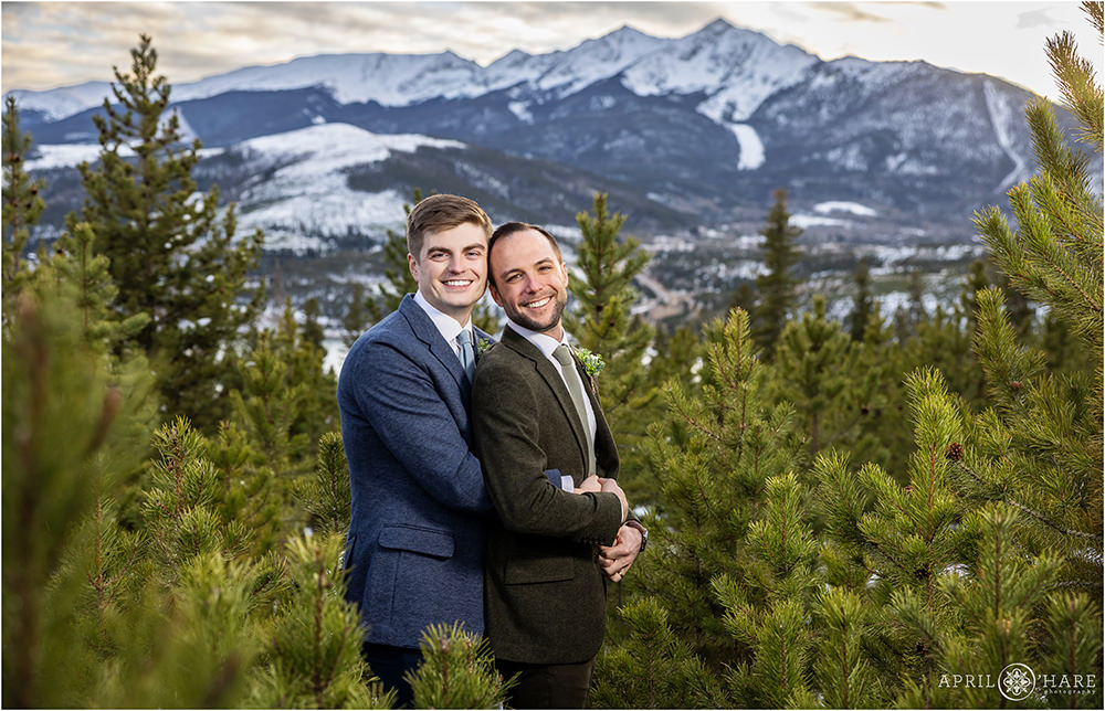 Cute portrait of two grooms on their wedding day with pretty mountain backdrop