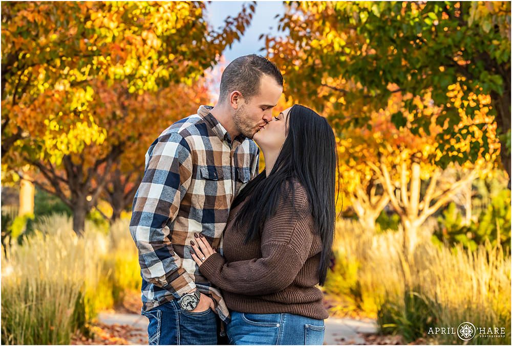 Couple Kiss with a Colorful Autumn Backdrop at Highlands Ranch Mansion in CO