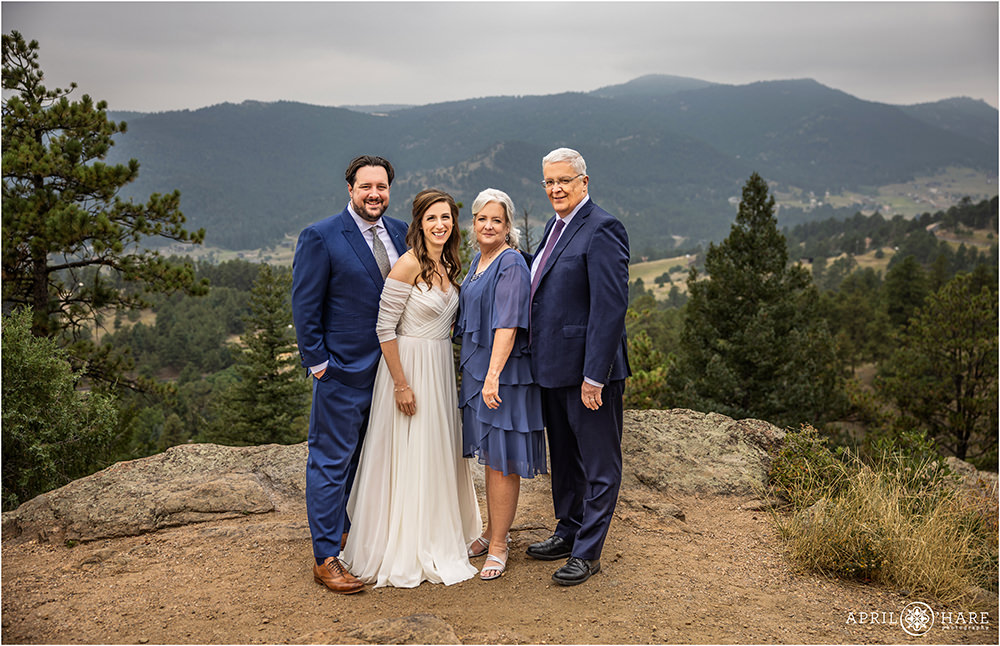 Family Portrait with a mountain backdrop for a wedding couple at West Mount Falcon Trailhead