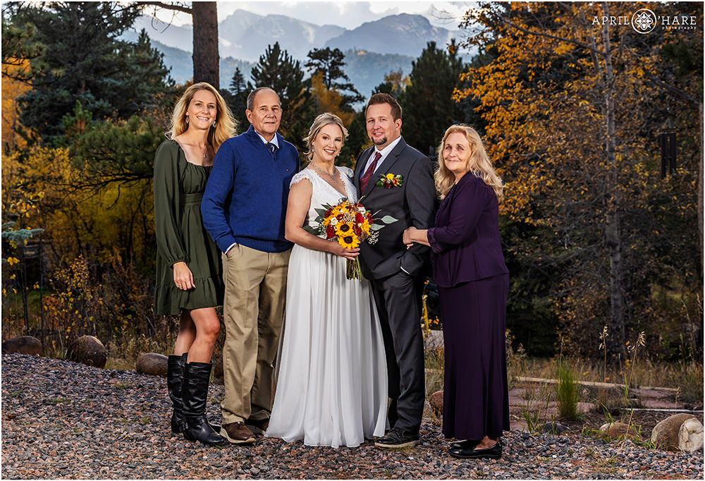 Family formal portrait with mountain backdrop at Romantic Riversong Inn in Estes Park Colorado