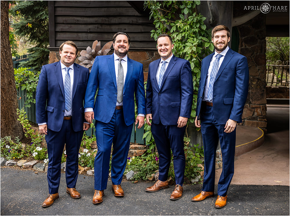 Casual portrait of Groom with his groomsmen at the Highland Haven Creekside Inn in Evergreen Colorado