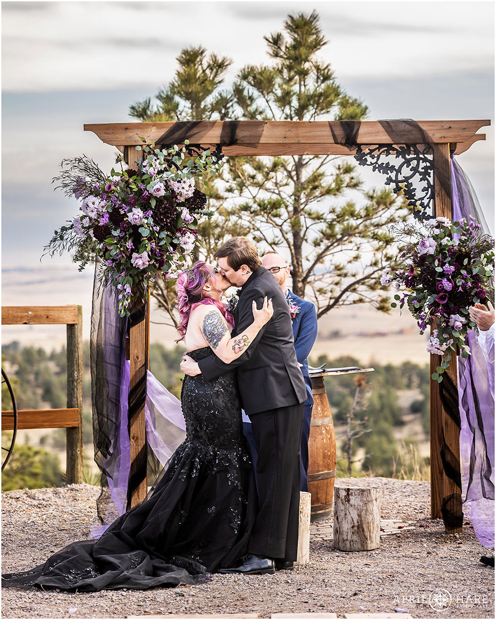 Bride and groom kiss at their outdoor wedding ceremony at Once Upon a Time