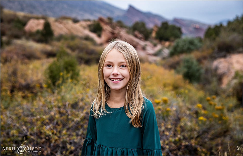 Girl smiles at her Colorado family photography session at East Mount Falcon Trailhead
