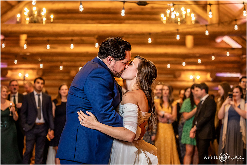 Groom kisses his bride at the end of their first dance at Evergreen Lake House